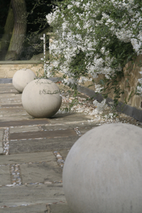 These stone balls on a roof terrace are uplit at night creating dramatic shadows