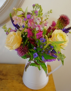 Jug with roses, agapanthus, mint, allium, snapdragon, stocks and veronica